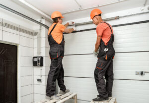 Help: Garage Door Not Opening All the Way - Men fixing garage door