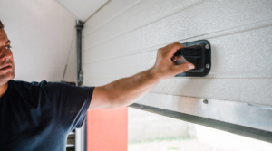 : Why is My Garage Door Uneven? What To Do Next - Man Pulling Open Garage