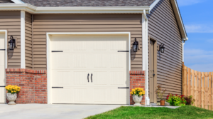 Exterior of a beige garage door - Will homeowners insurance cover the cost of garage door replacement?