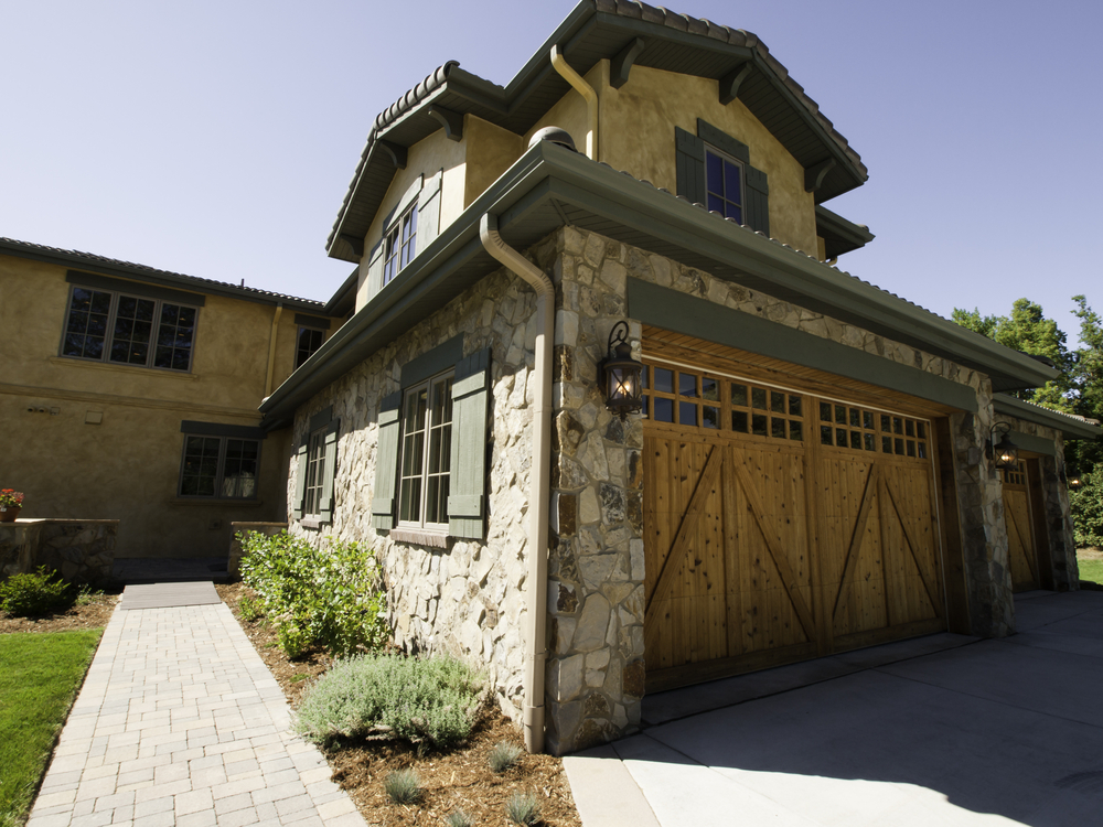 exterior of a home with wood garage door - Custom Garage Doors: From Wood to Finish and Everything In Between