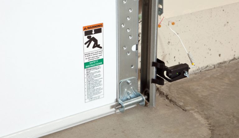 Garage door safety sensor with warning and safety instructions